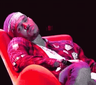 Man Laying In Red Chair With Bandana GIF