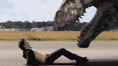 Man Laying Next To Dinosaur GIF