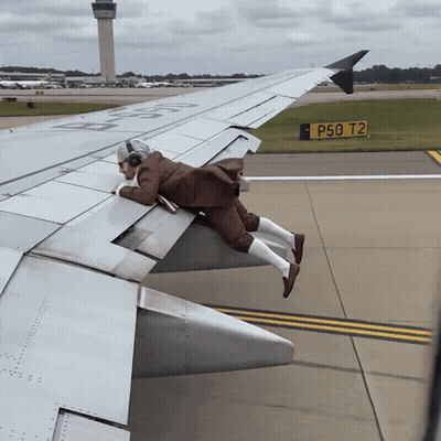 Man Laying On Airplane Wing With P50 T2 Sign GIF