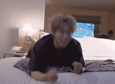 Man Laying On Bed In Hotel Room GIF