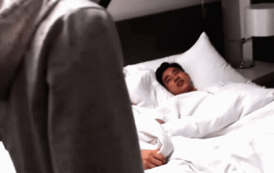 Man Laying On Bed Looking At Another Man GIF