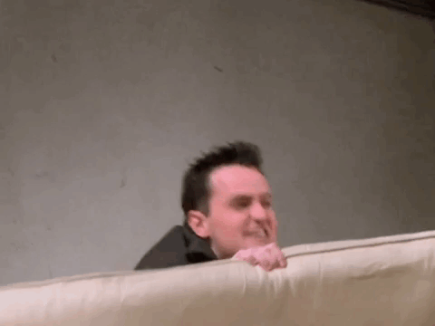 Man Laying On Bed Making Funny Face GIF