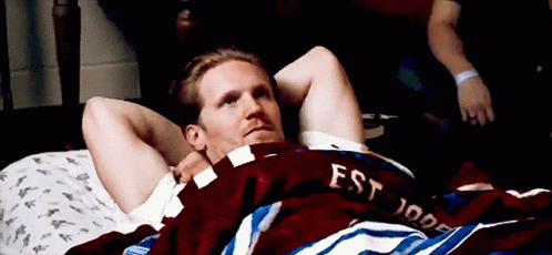 Man Laying On Bed With Est 1999 Shirt GIF