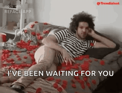Man Laying On Bed With Roses GIF