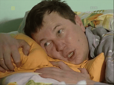 Man Laying On Bed With Seriale GIF