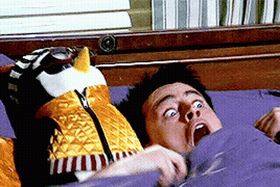 Man Laying On Bed With Stuffed Bird On Head GIF