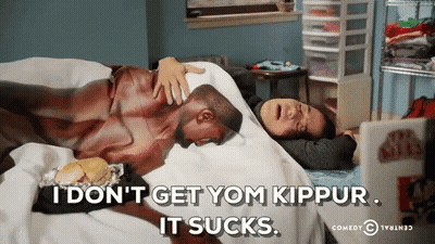 Man Laying On Bed With Woman Says I Don't Get Yom Kippur It Sucks GIF
