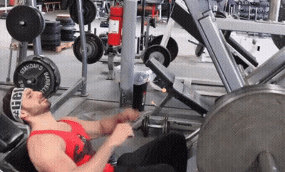 Man Laying On Bench In Red Tank Top GIF