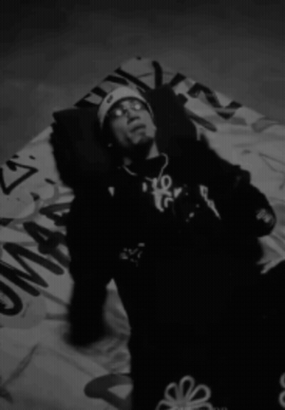 Man Laying On Blanket With Flower On Pants GIF
