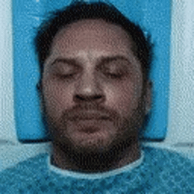 Man Laying On Blue Cushion With Eyes Closed GIF