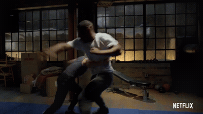 Man Laying On Blue Mat With Netflix Logo GIF
