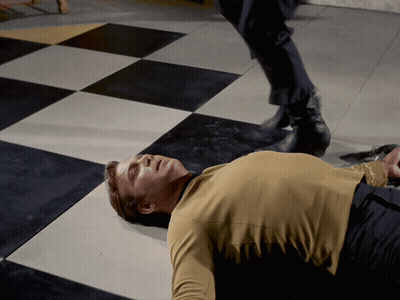 Man Laying On Checkered Floor GIF