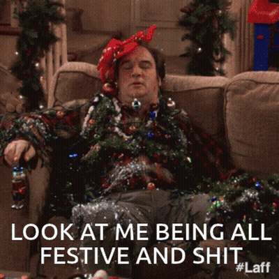 Man Laying On Couch Covered In Christmas Decorations Look At Me Being All Festive And Shit #Laff GIF