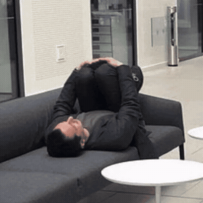 Man Laying On Couch Feet Up GIF