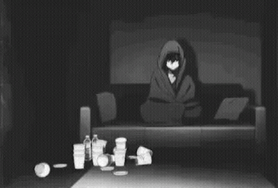 Man Laying On Couch In Dark Messy Room GIF