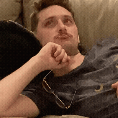 Man Laying On Couch In Glasses And Letter O Shirt GIF