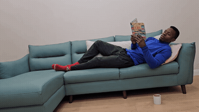 Man Laying On Couch Reading Book GIF