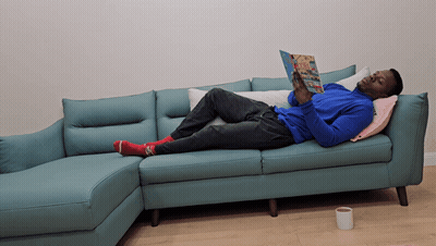 Man Laying On Couch Reading Magazine GIF