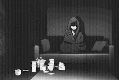 Man Laying On Couch Surrounded By Trash In Dark Room GIF