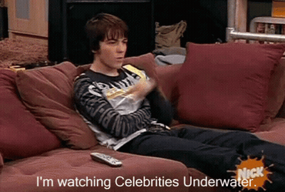 Man Laying On Couch Watching Celebrities Underwater GIF