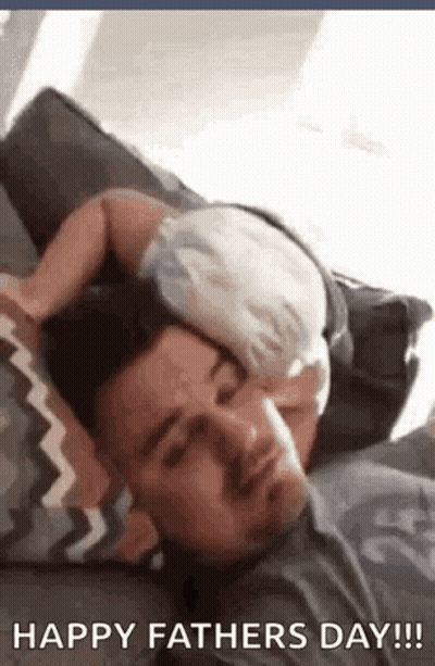 Man Laying On Couch With Baby Sleeping On His Head GIF