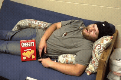 Man Laying On Couch With Cheez-It Box GIF