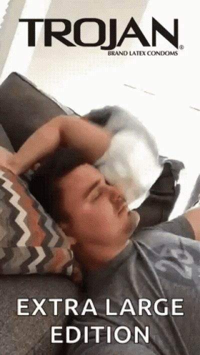 Man Laying On Couch With Trojan Condom On Head GIF