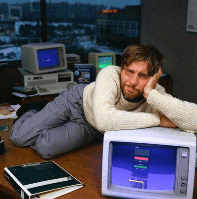 Man Laying On Desk With Microsoft Binder GIF