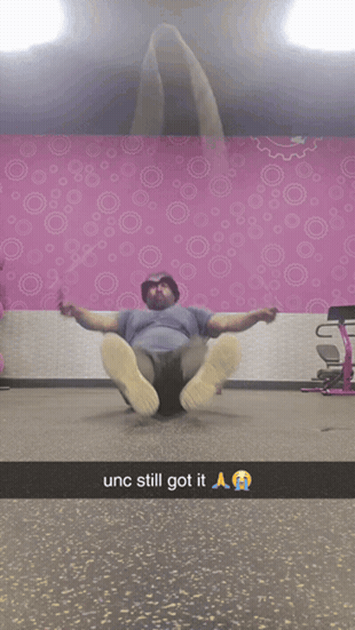 Man Laying On Floor By Pink Wall With Circles GIF