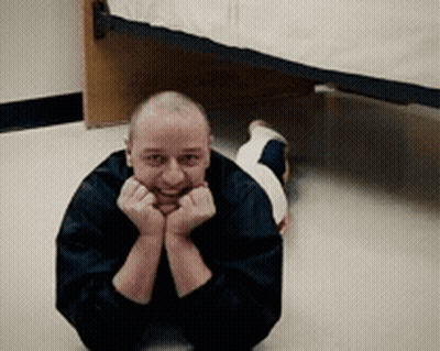 Man Laying On Floor Hands On Face GIF