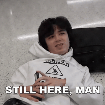 Man Laying On Floor In White Caution Hoodie GIF
