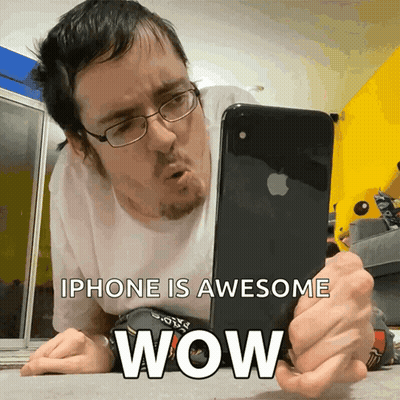 Man Laying On Floor Looking At IPhone Saying IPhone Is Awesome Wow GIF