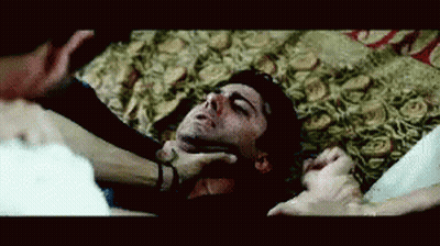 Man Laying On Floor With Eyes Closed Being Held By Neck GIF