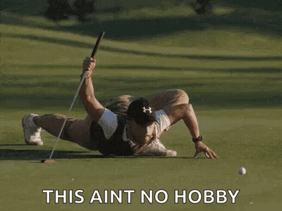 Man Laying On Golf Course Holding Club And Ball GIF