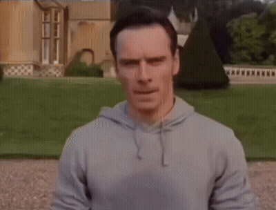 Man Laying On Ground Before Large House GIF