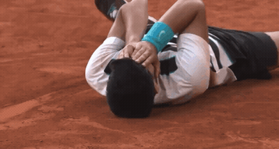 Man Laying On Ground Head In Hands With Wristband GIF