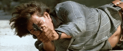 Man Laying On Ground Holding Gun GIF