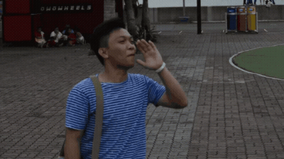 Man Laying On Ground In Front Of Ghowwheels Sign GIF