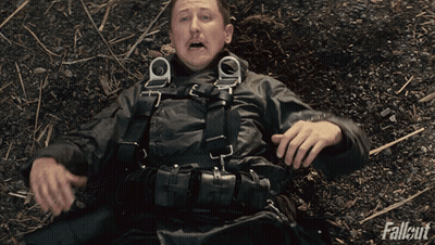 Man Laying On Ground With Fallout GIF