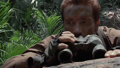 Man Laying On Log Looking Through Binoculars GIF