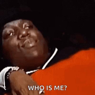 Man Laying On Red Blanket Smiling Asking Who Is Me GIF