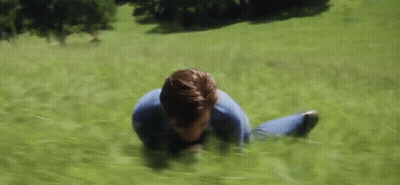 Man Laying On Stomach In Grassy Field GIF