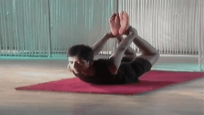 Man Laying On Yoga Mat With Feet Crossed GIF