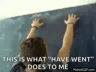 Man Leaning Against Blackboard GIF