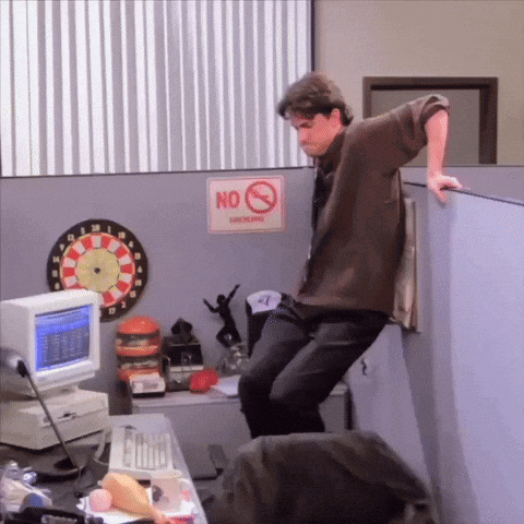 Man Leaning Against Cubicle Wall With No Smoking Sign GIF