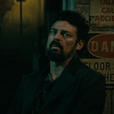Man Leaning Against Danger Sign GIF