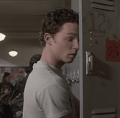 Man Leaning Against Locker With Sticker Saying 12 GIF