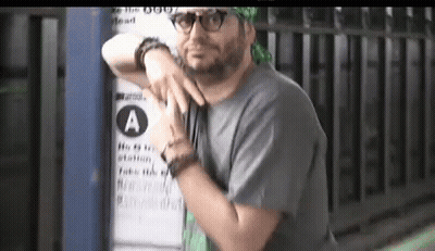 Man Leaning Against Sign Saying A GIF