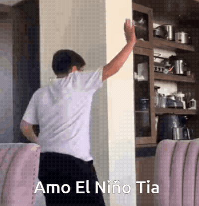 Man Leaning Against Wall With Arm Outstretched GIF