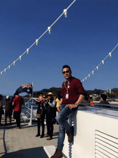 Man Leaning On Railing With Australian Flag GIF